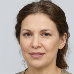 Joyful white adult female with medium  brown hair and grey eyes