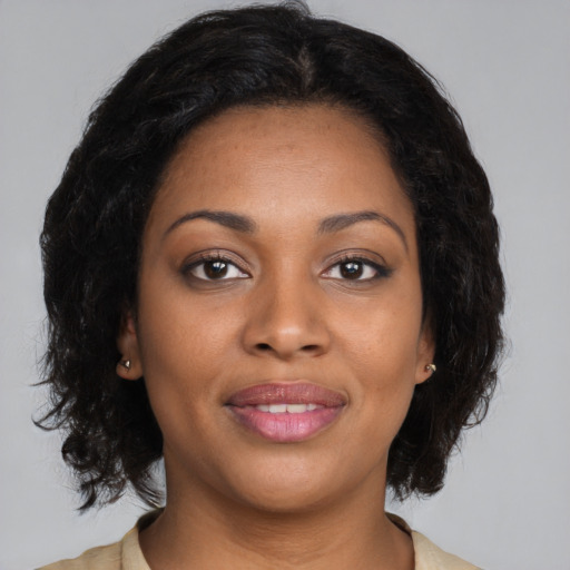 Joyful black young-adult female with medium  brown hair and brown eyes