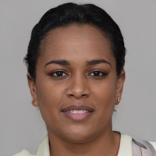 Joyful black young-adult female with short  brown hair and brown eyes