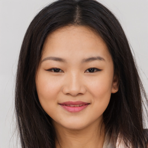 Joyful asian young-adult female with long  brown hair and brown eyes