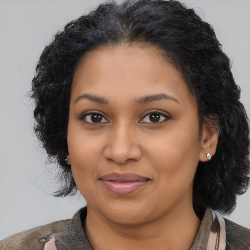 Joyful latino young-adult female with medium  black hair and brown eyes
