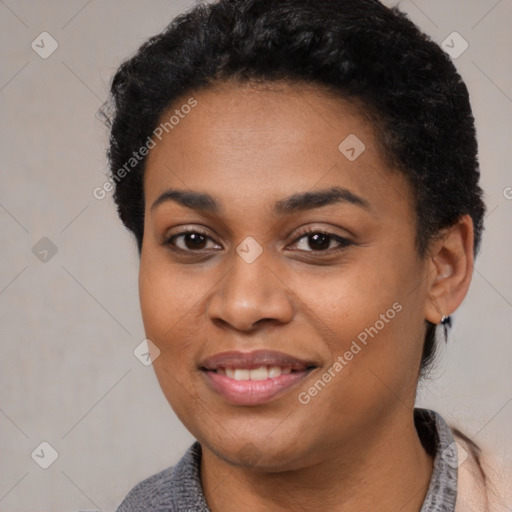 Joyful black young-adult female with short  black hair and brown eyes