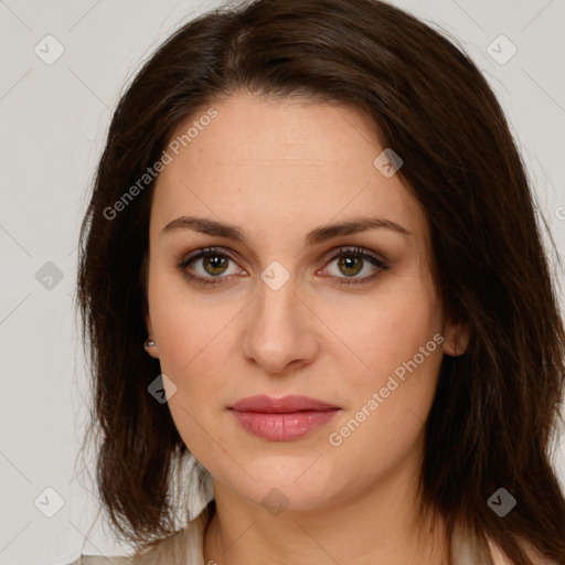 Joyful white young-adult female with long  brown hair and green eyes