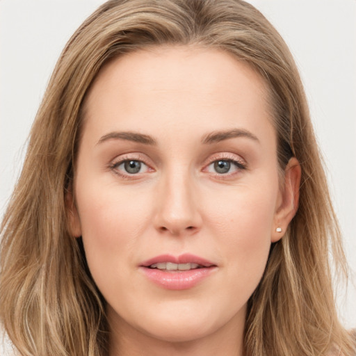 Joyful white young-adult female with long  brown hair and blue eyes