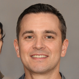 Joyful white young-adult male with short  brown hair and brown eyes