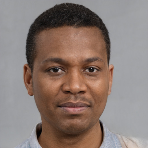 Joyful latino young-adult male with short  brown hair and brown eyes