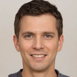 Joyful white young-adult male with short  brown hair and brown eyes