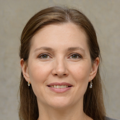 Joyful white adult female with medium  brown hair and grey eyes