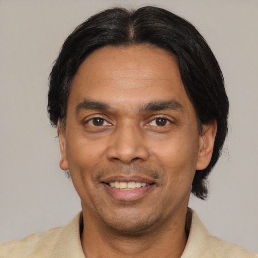 Joyful latino adult male with short  black hair and brown eyes