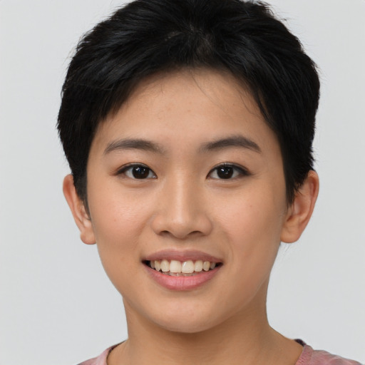 Joyful asian young-adult female with short  brown hair and brown eyes