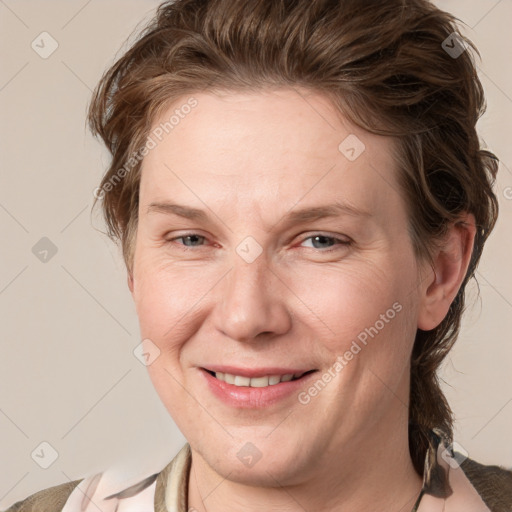 Joyful white adult female with medium  brown hair and blue eyes