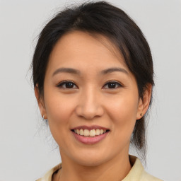 Joyful asian young-adult female with medium  brown hair and brown eyes