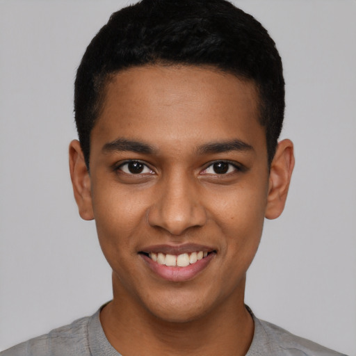 Joyful latino young-adult male with short  black hair and brown eyes