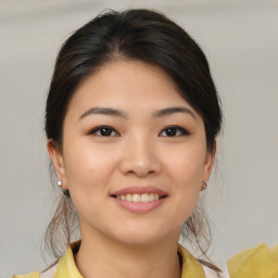 Joyful asian young-adult female with medium  brown hair and brown eyes