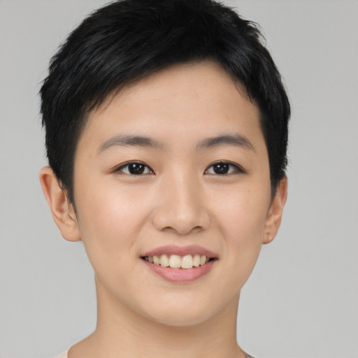 Joyful asian young-adult female with short  black hair and brown eyes