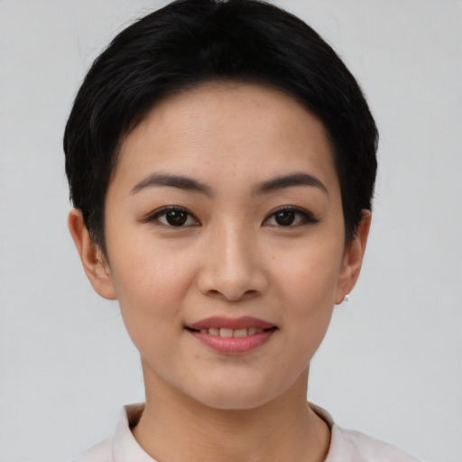 Joyful asian young-adult female with short  black hair and brown eyes