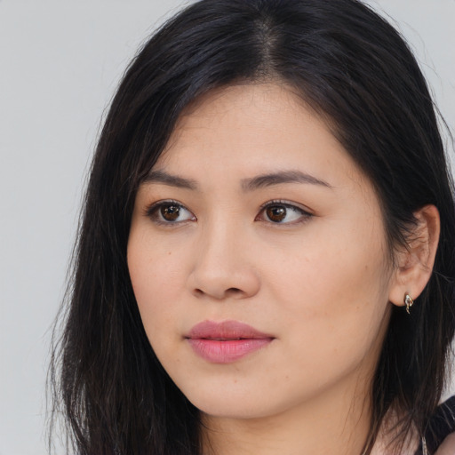 Joyful asian young-adult female with long  brown hair and brown eyes