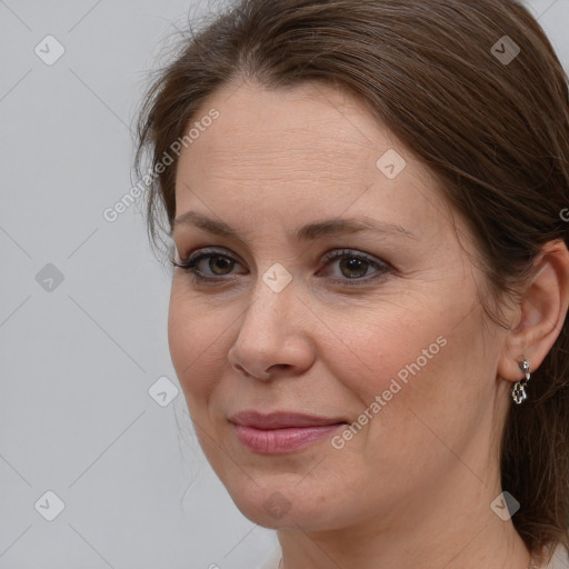 Joyful white adult female with medium  brown hair and brown eyes