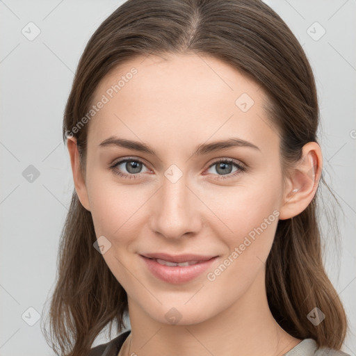 Joyful white young-adult female with long  brown hair and grey eyes