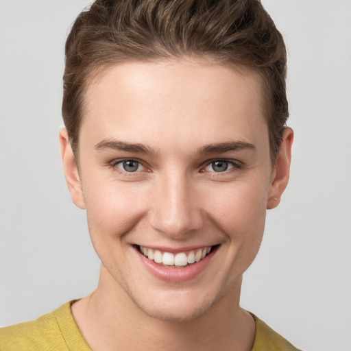 Joyful white young-adult female with short  brown hair and grey eyes