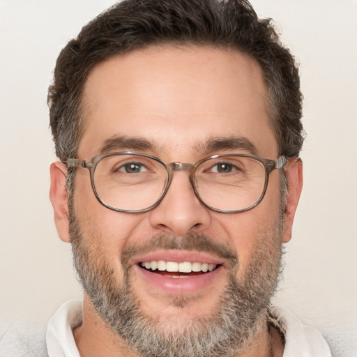 Joyful white adult male with short  brown hair and brown eyes