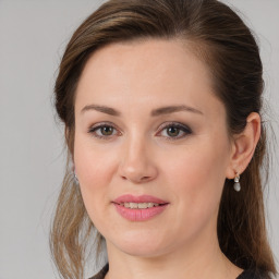 Joyful white young-adult female with long  brown hair and brown eyes