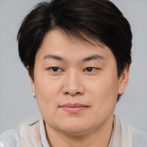 Joyful asian young-adult female with short  brown hair and brown eyes