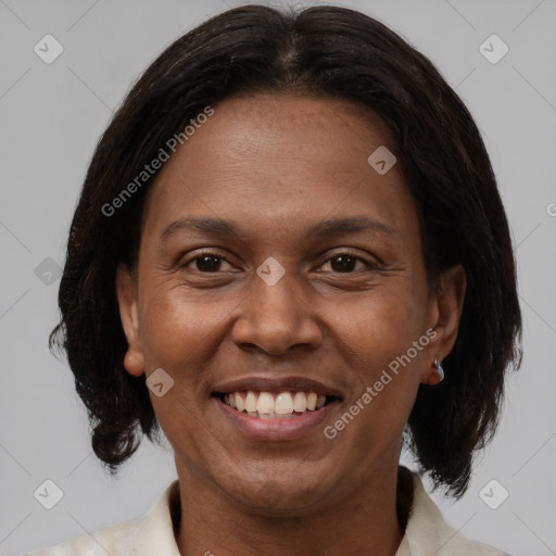 Joyful black adult female with medium  brown hair and brown eyes