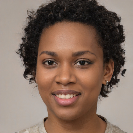 Joyful black young-adult female with medium  black hair and brown eyes