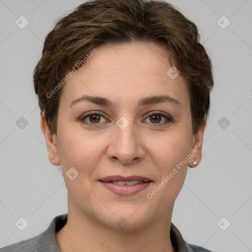 Joyful white young-adult female with short  brown hair and grey eyes