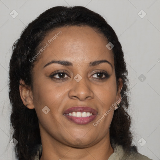 Joyful black adult female with medium  brown hair and brown eyes