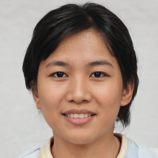 Joyful asian young-adult female with medium  brown hair and brown eyes