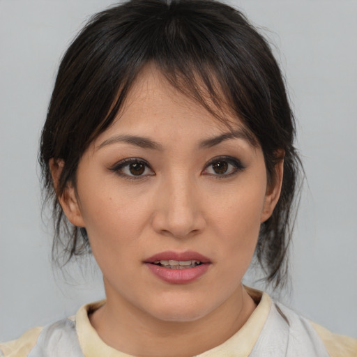 Joyful asian young-adult female with medium  brown hair and brown eyes