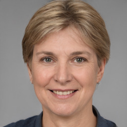 Joyful white adult female with medium  brown hair and grey eyes