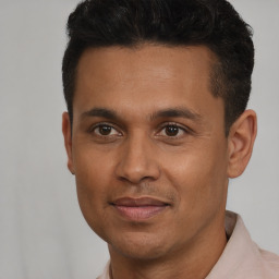 Joyful latino young-adult male with short  brown hair and brown eyes