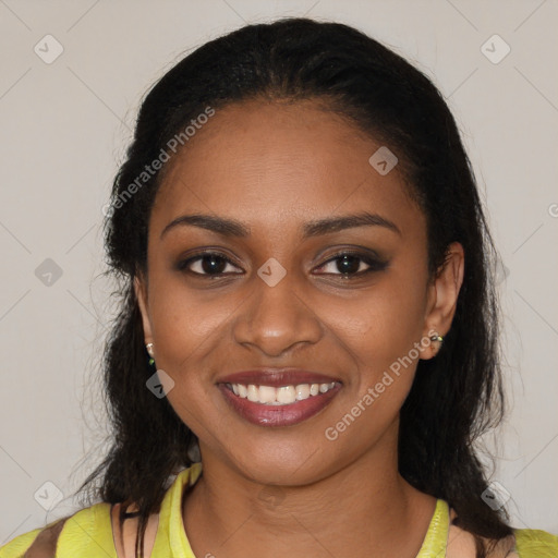 Joyful black young-adult female with long  black hair and brown eyes