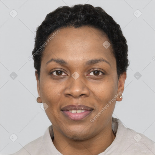 Joyful black adult female with short  black hair and brown eyes