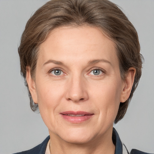 Joyful white adult female with medium  brown hair and grey eyes