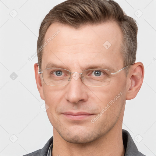 Joyful white adult male with short  brown hair and grey eyes