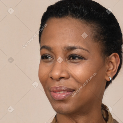 Joyful black young-adult female with short  black hair and brown eyes