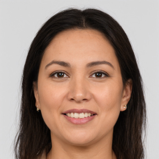 Joyful white adult female with long  brown hair and brown eyes