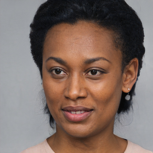 Joyful black young-adult female with medium  black hair and brown eyes