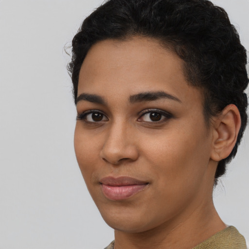 Joyful latino young-adult female with short  black hair and brown eyes
