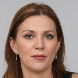 Joyful white adult female with long  brown hair and grey eyes