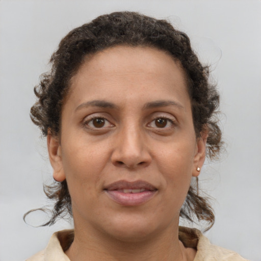 Joyful black adult female with short  brown hair and brown eyes