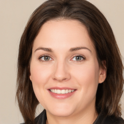 Joyful white young-adult female with medium  brown hair and brown eyes