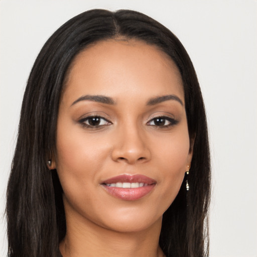 Joyful latino young-adult female with long  brown hair and brown eyes