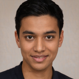 Joyful latino young-adult male with short  brown hair and brown eyes