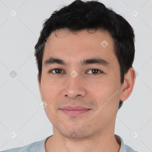 Joyful asian young-adult male with short  black hair and brown eyes