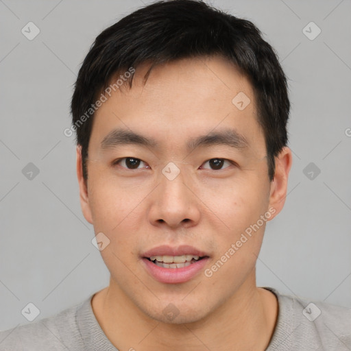 Joyful asian young-adult male with short  black hair and brown eyes